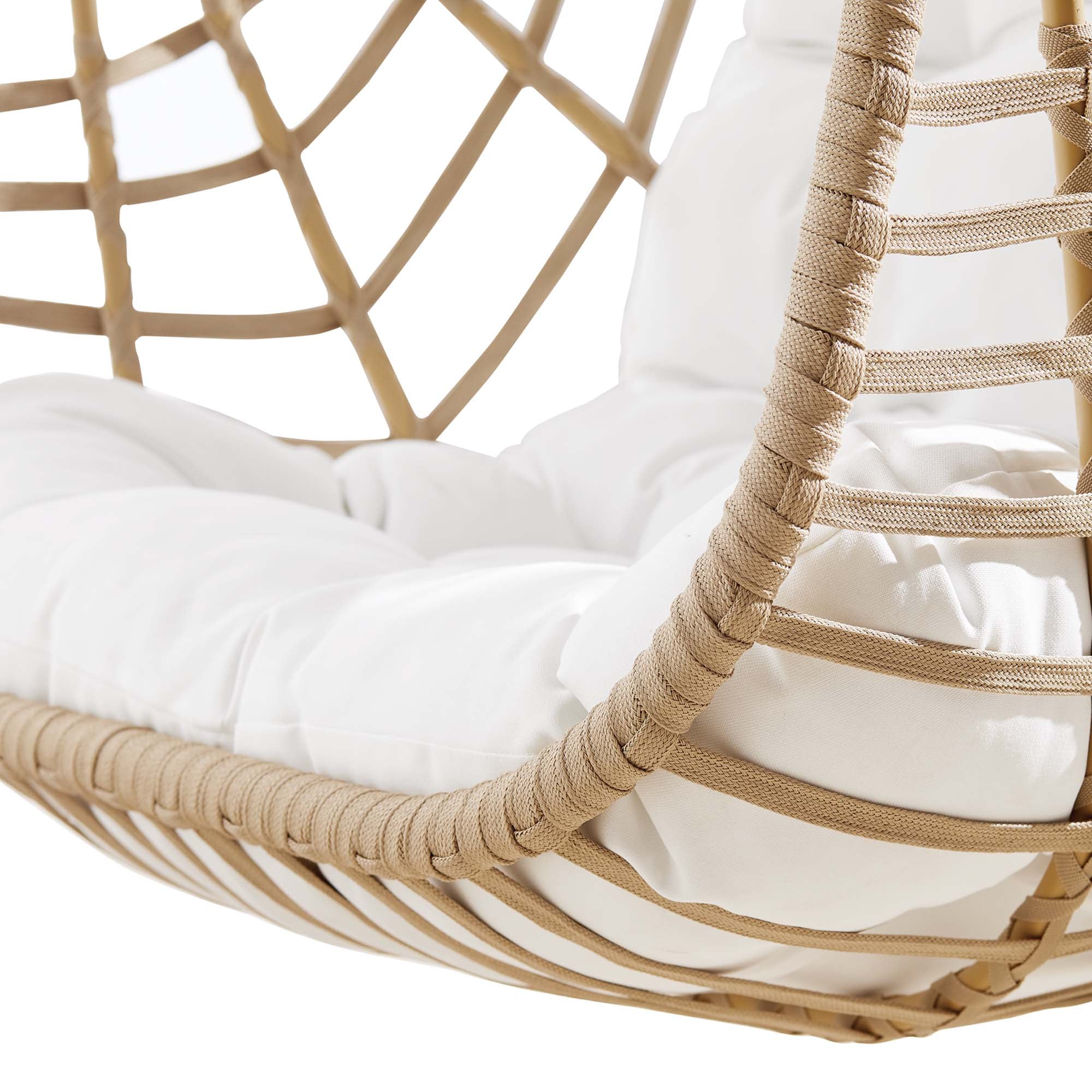 Wicker hanging swing chair cushion close-up with white padding and braided rattan rings.