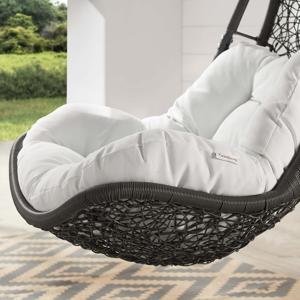 Outdoor hanging swing chair cushion with plush white padding and black woven edge