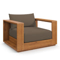 Outdoor patio acacia lounge chair with dark cocoa cushions, armrests and open side panel