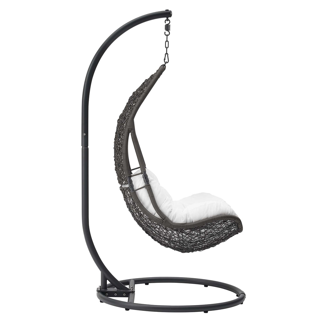 Hanging swing chair with dark gray frame, black woven pod seat, and white cushion
