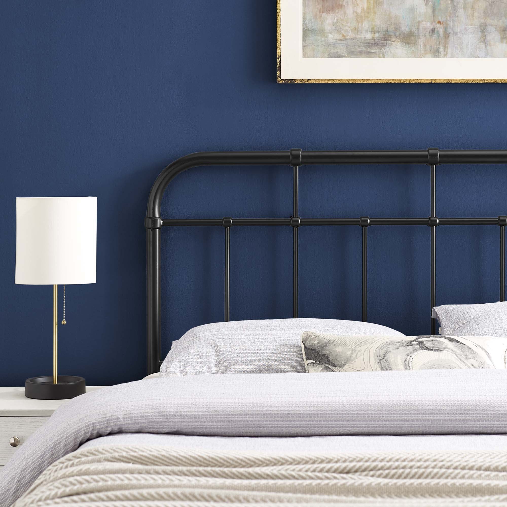 Metal headboard with vertical bars and rounded top rail in dark finish
