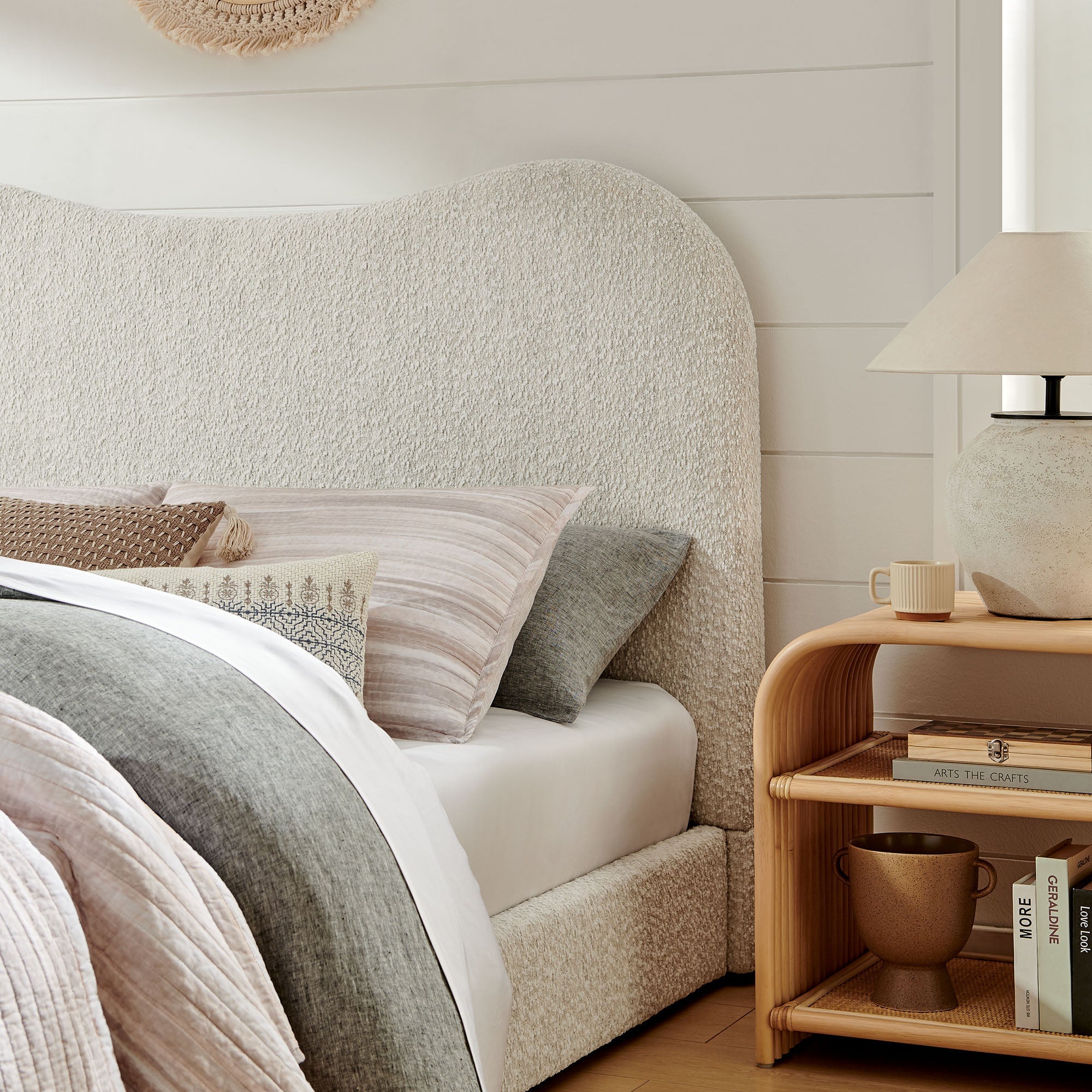 Boucle upholstered queen platform bed with curved headboard and upholstered side panels
